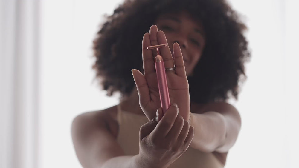 Woman using Tona facial roller
